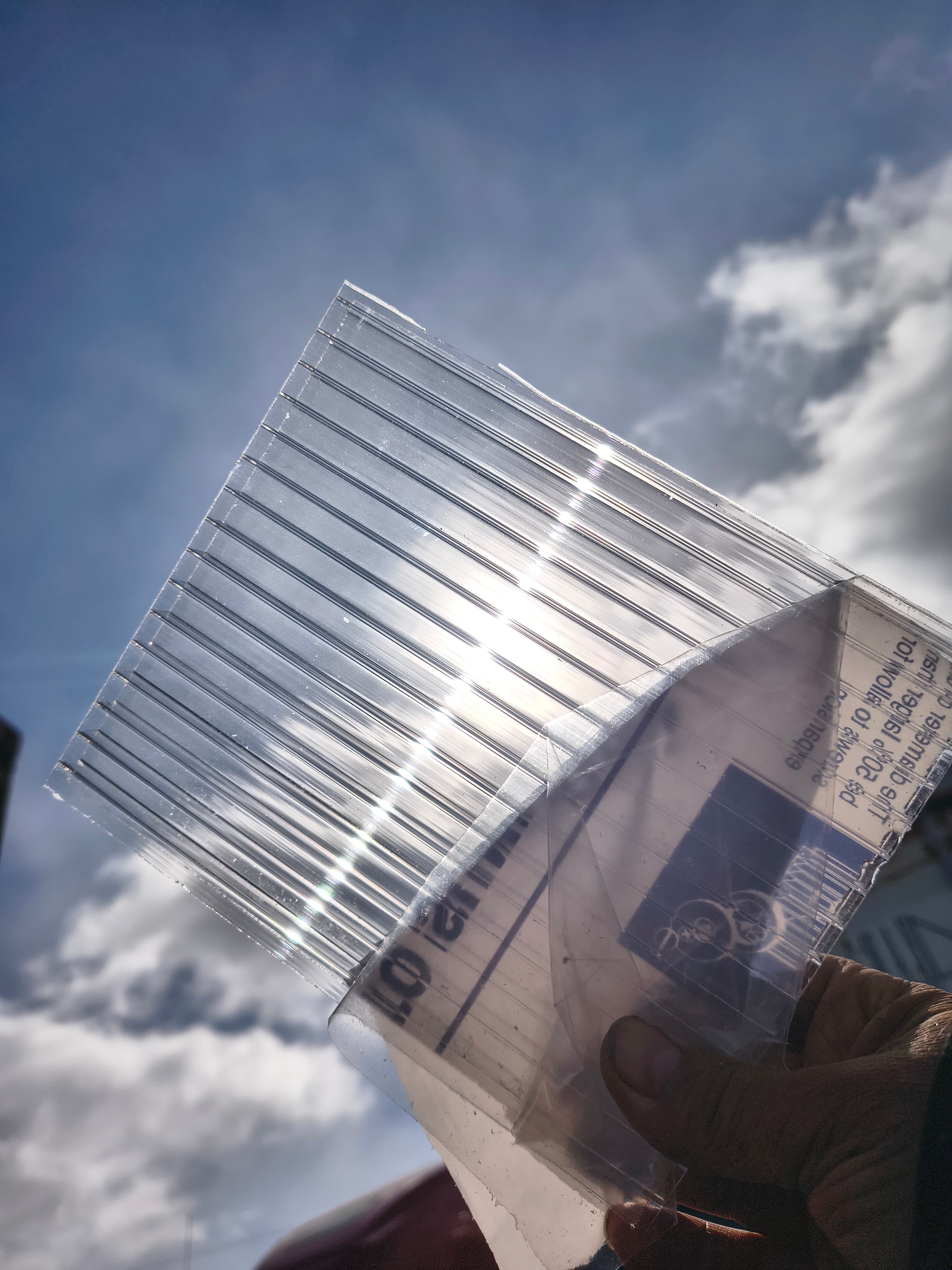 Clear polycarbonate sheet demonstrating light transmission and clarity