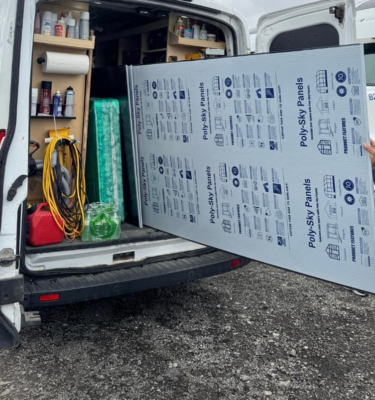 Polycarbonate panels being loaded from van
